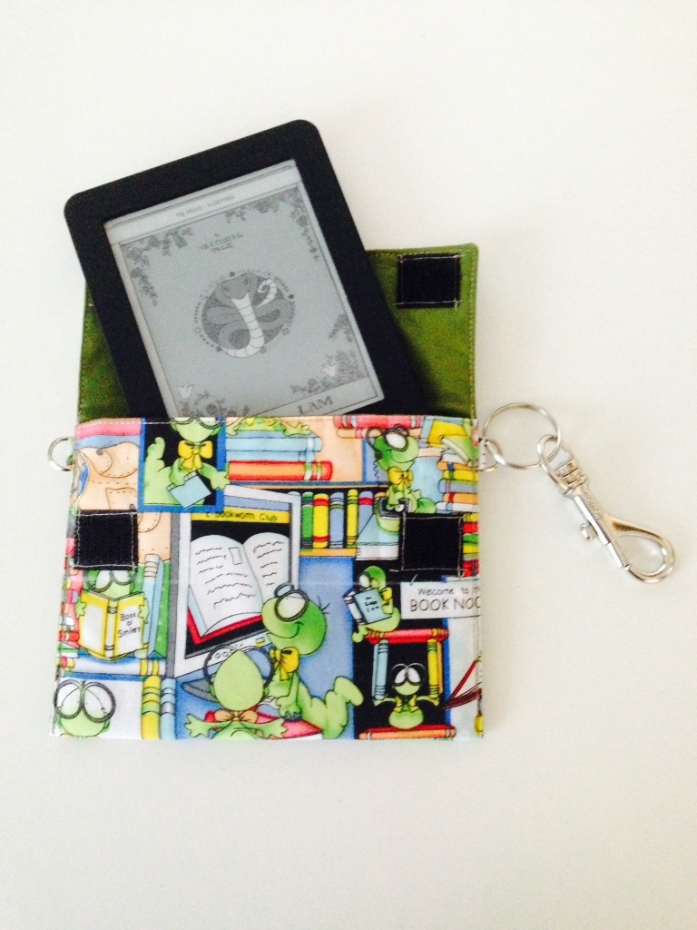 Photo of my custom Kobo case, with bookworm fabric and my Kobo peeking out
