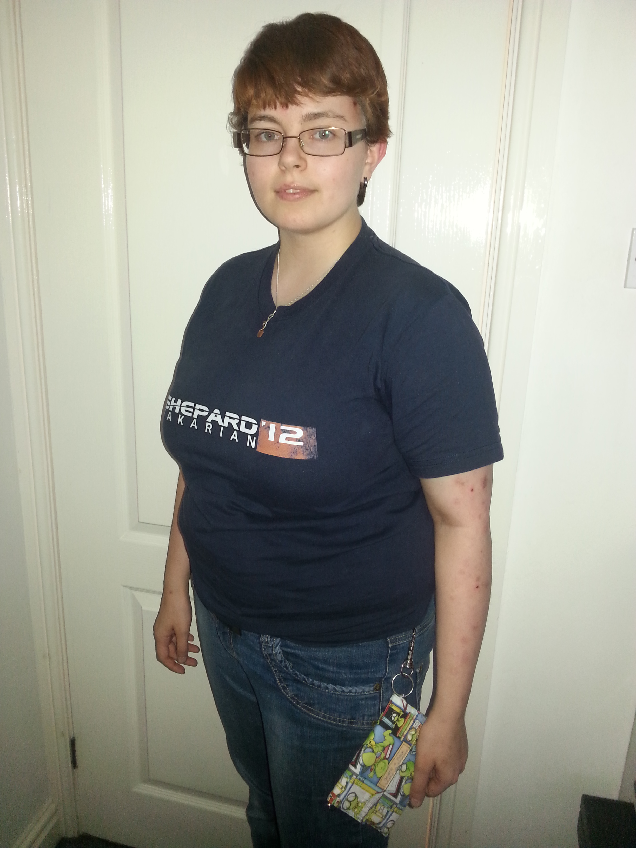 Photo of me, wearing a Mass Effect t-shirt and modelling my new Kobo case