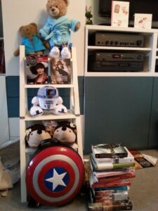 Photo of my gifts all together, including a stack of books and a shield backpack
