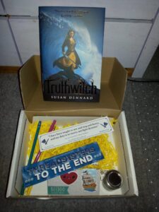 Photo of the second Illumicrate box, including the book Truthwitch and some extra goodies