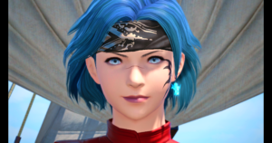 Slightly tweaked screenshot of my character from Final Fantasy XIV, a human with short blue hair, pale blue eyes, and a black curling facial tattoo on the left side of their face. They wear an earing of a cute litte critter, and their hair is held back by a black bandanna. You can see the collar of their athletic shirt, which is red.