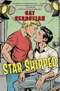 Cover of Star Shipped by Cat Sebastian; the cover is clearly on a movie/TV set, with one dark-haired man in a chair and a blond-haired man leaning over him. They look about to kiss. The font for the author's name and title is a bit comic-booky, or like the covers of pulpy fiction.
